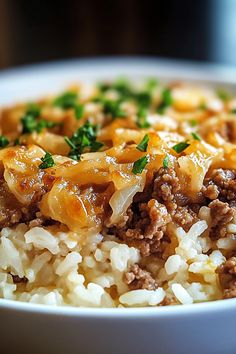 a white bowl filled with rice and meat