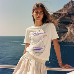 Introducing our vintage-style, distressed mediterranean line of tees, a perfect blend of timeless style and coastal charm. Featuring distressed printing for a quaint, retro feel, this shirt evokes the relaxed and sun-kissed spirit of the Mediterranean. Ideal for those who appreciate a classic look with a touch of nostalgia, it's perfect for casual outings and seaside strolls. Embrace the essence of coastal living with this effortlessly stylish piece. Made from very soft materials, this tee is 100% cotton. The shoulders have twill tape for improved durability. There are no side seams. The collar is made with ribbed knitting to prevent curling damage.  *Made with 100% ring-spun cotton, a lightweight fabric (4.5 oz/yd² (153 g/m this unisex t-shirt feels like a bliss to wear all year round.  * Summer Graphic Print Crew T-shirt, Casual Cotton T-shirt For Sailing, Nautical Cotton T-shirt For Summer, Nautical Beach Tops For Summer, Nautical Style Beach Tops For Summer, Nautical Tops For Beach In Summer, White Nautical Short Sleeve Tops, White Nautical Tops For Vacation, Nautical Short Sleeve Cotton Tops