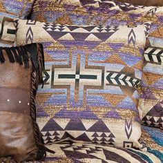 the pillows on the couch are made with native american fabric and leather fringe trims