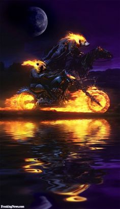 a man riding on the back of a motorcycle with flames coming out of its tires