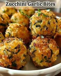 some food is in a white bowl on a table with the words zucchini garlic bites