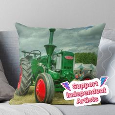 a green tractor with red rims on the front and side, sitting in a field throw pillow