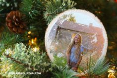 a christmas ornament hanging from a pine tree