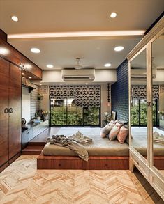 a bedroom with a large bed and mirrored walls