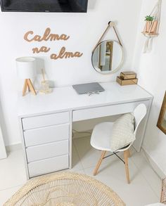 a white desk topped with a mirror and a laptop computer