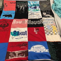 there is a bed with many different shirts on it