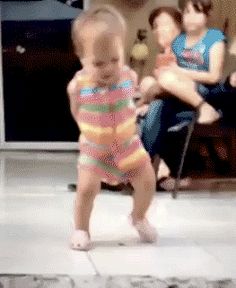 a young child is dancing on the floor