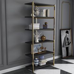 a white and gold shelving unit with pictures on the wall next to it in a room