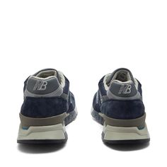 Capture the timeless Americana style of New Balance with their U998NV Made in USA sneakers. Navy leather and suede ups exude both durability and vintage flair, while ABZORB cushioning provides unbeatable comfort for your daily adventures. Proudly stepping in a symbol of quality craftsmanship, the iconic 'N' logo and 'Made in USA' badge honor NB's dedication to heritage manufacturing. Sporty Navy Suede Sneakers, Navy Suede Sneakers With Round Toe, Navy Suede Round Toe Sneakers, Custom New Balance Lace-up Leather Sneakers, New Balance Custom Leather Lace-up Sneakers, Custom Leather Lace-up New Balance Sneakers, Navy Sneakers With Vibram Sole For Streetwear, Classic Navy Sneakers With Leather Sole, Classic New Balance Leather Custom Sneakers