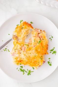 a white plate topped with an omelet covered in cheese