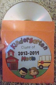 a hand holding an orange card with the words kindergann class of 2013 - 2014 on it