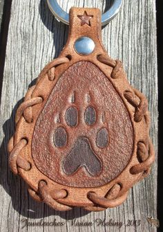 a leather keychain with a dog's paw on it