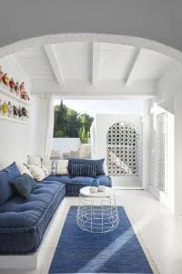 a living room with white walls and blue couches in the middle of the room