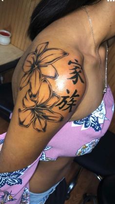 a woman with a flower tattoo on her arm