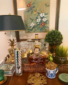 a wooden table topped with lots of bottles and glasses