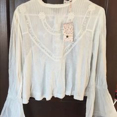 Free People New With Tags $108.00 Retail Xs Viscose/ Linen Gorgeous Peasant Boho Top With Wide Sleeves, Embroidered And Lace Appliqus, Buttons Down In The Back. Fits Cropped. Festival Ready! Bust (Underarm To Underarm)- 19” Length (Shoulder To Bottom Hem)-19.5” Necklace Is Not Included P Casual White Blouse With Boho Collar, Casual Lace Trim Blouse For Festivals, White Spring Blouse With Boho Collar, White Boho Collar Blouse For Spring, Long Sleeve Top With Lace Trim For Festivals, Long Sleeve Tops With Lace Trim For Festival, White Blouse With Boho Collar For Spring, White Peasant Top With Boho Collar, White Bohemian Peasant Top With Boho Collar