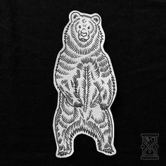 a bear sticker sitting on top of a black surface