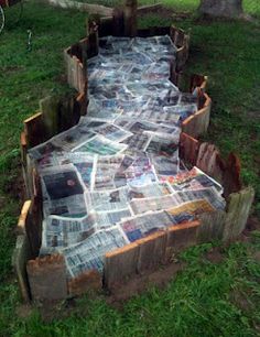 a wooden bench made out of newspapers on the grass