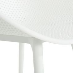 the underside of a white plastic chair