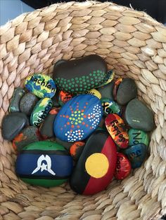 a basket filled with lots of colorful rocks