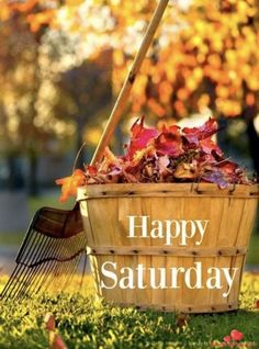 a basket full of leaves with the words happy saturday written on it and a rake