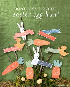 an easter tree with paper cutouts and bunnies on it, in front of a green background