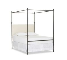 an iron bed frame with white sheets and pillows on the bottom, against a white background