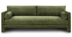 a green couch sitting on top of a white floor