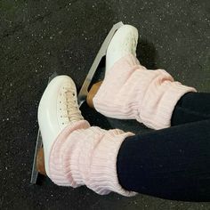 a person wearing pink socks and white shoes