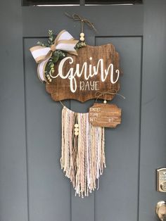 a wooden sign hanging on the side of a gray door that says gavin'kash