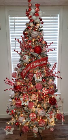 a christmas tree decorated with red and white ornaments