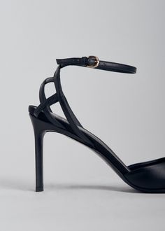 Round toe d'orsay heel in calfskin leather. Contrast basket weave counter. Adjustable ankle strap with brass buckle. Made in Italy. Details 100% Calfskin Black 0511AGN-BLA True to size Heel height: 87mm approx 3.5" Ankle Strap Sandals With 4-inch Heel For Galas, Luxury Heels With Ankle Strap And Heel Strap, Luxury Heels With Heel And Ankle Strap, Luxury Heels With Ankle Strap, Sleek Court Shoes With Heel And Ankle Strap, Workwear Court Shoes With Leather Sole Ankle Strap, Sleek Heels With Leather Sole And Ankle Strap, Timeless Leather Ankle Strap Heels, Sleek Heels With Ankle Strap And Leather Sole