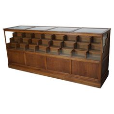 a large wooden display case with many compartments