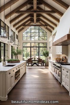 a large kitchen with an open ceiling and wooden flooring is shown in this image