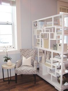 a living room filled with furniture next to a window