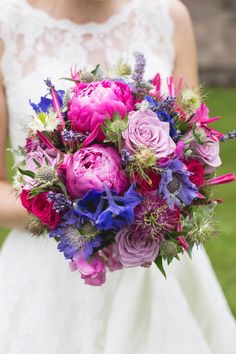 a bride holding a bouquet of flowers in her hands