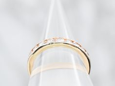 a close up view of a wedding ring with diamonds on the top and bottom side