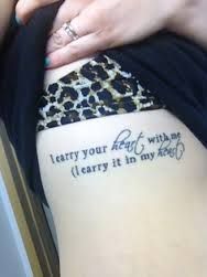 a woman with a tattoo on her thigh that reads, i carry your feet with me carry it in my heart