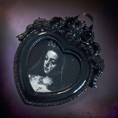 a black and white photo frame with a woman's face in the center, on a purple background