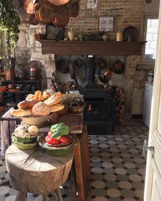 a kitchen filled with lots of food and cooking utensils on top of a wooden table