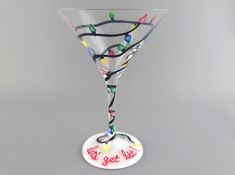 "Fun and festive martini cocktail glass for Christmas and the holidays. Each glass will be just a little bit different due to being hand painted. You can choose to change the text on the base if you want to in the personalization area. Listing is for one hand painted glass. Please see photos and description below for choice of glass shape and size. NOTE: We almost always have some sort of QUANTITY DISCOUNT(S) available. These discounts will show up automatically when you have multiple items in y Martini Glass Painting Ideas, Martini Glass Painting, Painted Martini Glasses, Painted Wine Glasses Christmas, Christmas Martini, Lets Get Lit, Christmas Glasses, Christmas Cocktail, Hand Painted Christmas