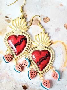 Detailed and beautiful hand painted earrings with the sacred heart with thorns and decorated with small slices of watermelon. The earrings are protected with several layers of high-quality jewelry varnish, improving the quality and durability of the earrings. These earrings are inspired by our Mexican culture and hand painted; They are the ideal gift because they combine with any outfit both day and night, enhancing the beauty of the person who receives them and attracting attention for being unique hand-painted pieces, the Ideal gift for Mother's Day and holidays. Features/ Product info Note: Each earring is hand painted, there are small differences between each pair, so each pair of earrings in this store is unique. -Large: 2 in  (Please see the photos, this design comes in two sizes.) - Artistic Handmade Heart Earrings For Gift, Unique Handmade Heart Earrings, Multicolor Jewelry For Valentine's Day Festival, Handmade Heart-shaped Jewelry For Festivals, Unique Handmade Dangle Heart Earrings, Nickel Free Heart Earrings For Festivals, Unique Handmade Heart Dangle Earrings, Artistic Hand Painted Jewelry For Valentine's Day, Handmade Adjustable Earrings For Valentine's Day