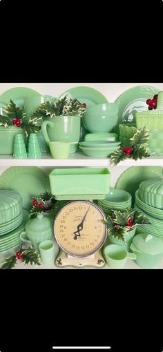 a shelf filled with green dishes and christmas greenery on top of eachother