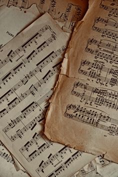 old sheet music sheets are piled on top of each other with musical notes all over them