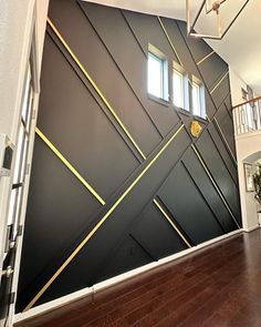 an open door leading to a room with black walls and gold trim on the wall