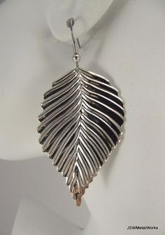 These earrings are so lightweight, detailed and cute! They are perfect for an evening out. Textured shiny silver leaves lightly dangle on stainless steel ear wires, for those with sensitive ears. These can be switched out to silver plated clip-ons, for those with non-pierced lobes. Simply select that option before adding to your cart. A classy, yet attention-getting piece to add to your collection. Height from top of ear wire to bottom: 2.5 inches Widest point on leaves: 1.25 inches (#3807) Due Nickel Free Leaf-shaped Metal Earrings, Nickel-free Leaf-shaped Metal Earrings, Nickel-free Metal Leaf-shaped Earrings, Nickel-free Metal Leaf Earrings, Silver Leaf-shaped Pierced Earrings, Silver Leaf-shaped Metal Earrings, Silver Leaf Earrings, Woodland Jewelry, Silver Leaves