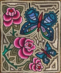 an embroidered square with flowers and butterflies on it