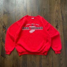 Vintage 1990s Detroit Red Wings NHL Hockey Crewneck Sweatshirt / tag size Medium (see measurements) Pit to Pit:     21" Length:     23" Sleeve:   26" Please check the measurements before purchasing.  -------------------------------- ⚠️ Please Note: All of our items are vintage. Please note that with vintage clothing, items may show some signs of wear. We do our best to include as much information about the items condition as possible. Please look carefully through the photos and feel free to rea Red Oversized 90s Tops, Oversized 90s Red Top, Vintage Red Crew Sweatshirt, Red Vintage Crew Sweatshirt, Vintage Red Crew Neck Tops, 90s Red Cotton Sweatshirt, Vintage Red Cotton Sweatshirt, Red College Sweatshirt With Letter Print, 90s Style Red Sweatshirt With Letter Print