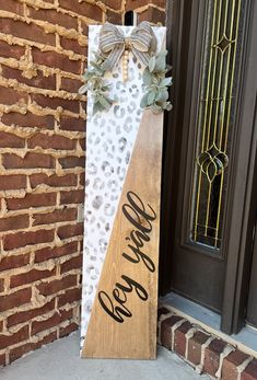 a wooden sign that says welcome to the front door