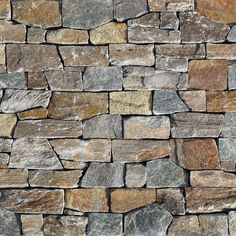 a stone wall made out of different colored rocks